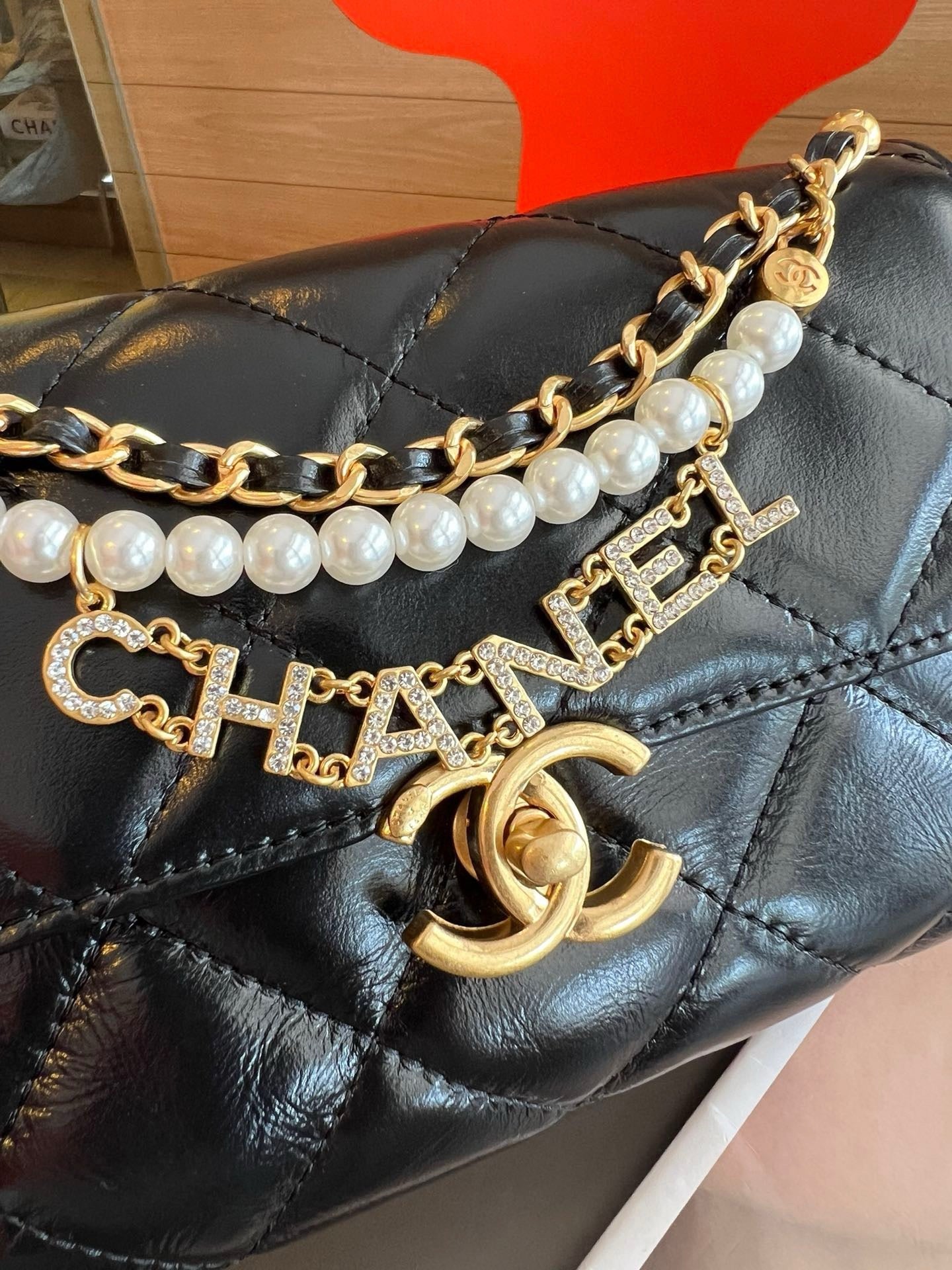 CE-24A pearl necklace flap bag